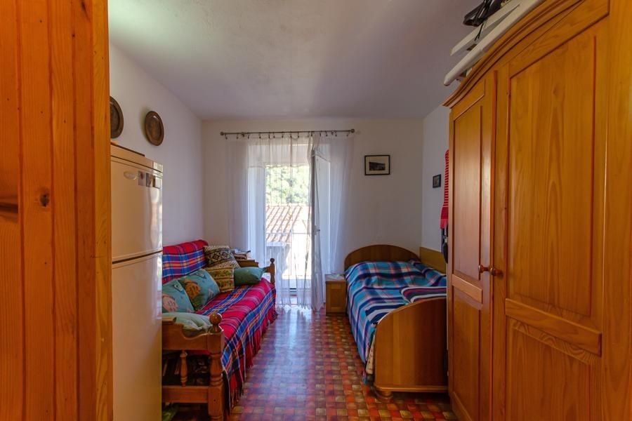 Schlafzimmer mit Kleiderschrank und Balkon