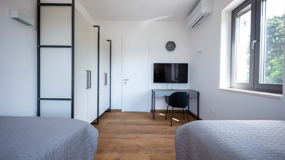 Zimmer mit zwei Betten und Arbeitsbereich