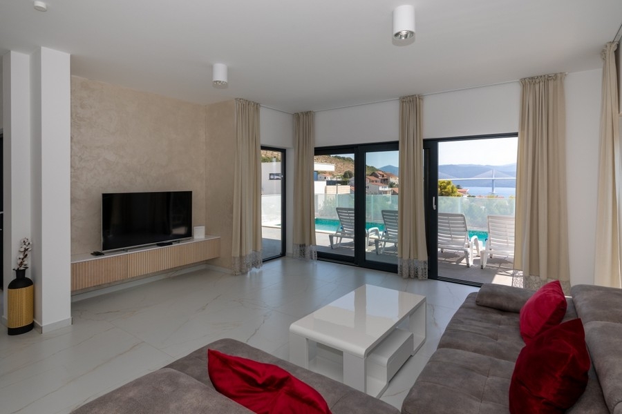 Modernes Wohnzimmer mit Zugang zur Terrasse und Pool