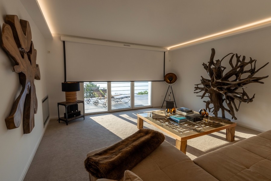 Wohnzimmer mit großen Fensterfronten und Meerblick