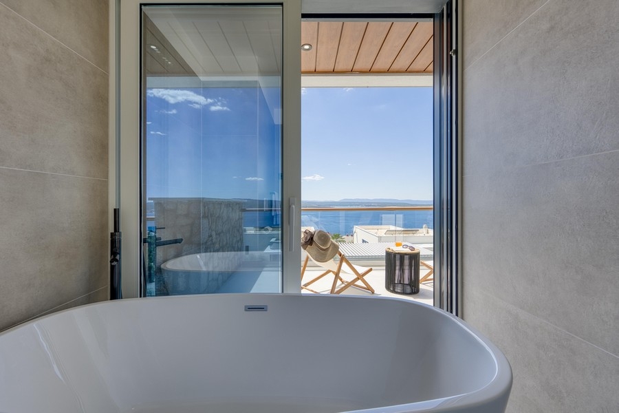 Badezimmer mit freistehender Badewanne und Meerblick