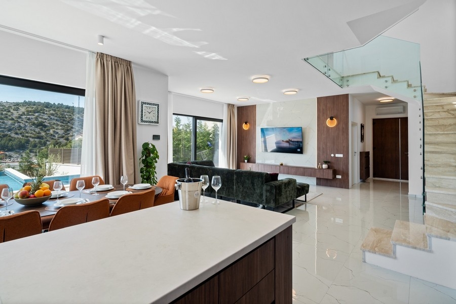 Heller Wohnraum mit Küche und Zugang zur Poolterrasse