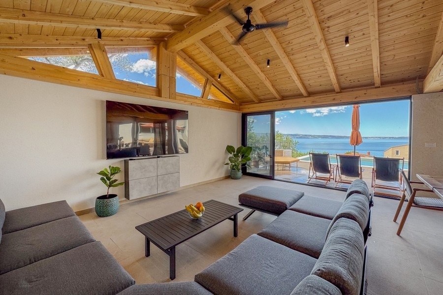Wohnzimmer mit großen Glasfronten und Meerblick