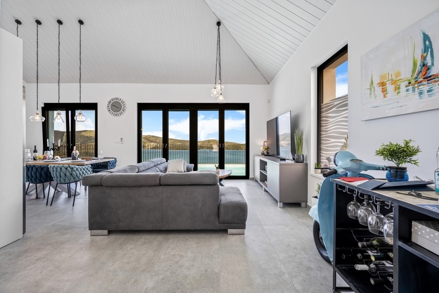 Offener Wohnbereich mit Sofa und hoher Decke