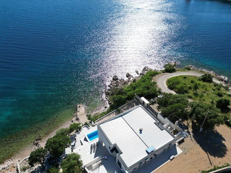 Kristallklares Meer und Felsstrand unterhalb der Villa