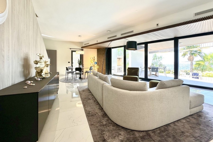 Wohnbereich mit Sofa und großen Glasfronten