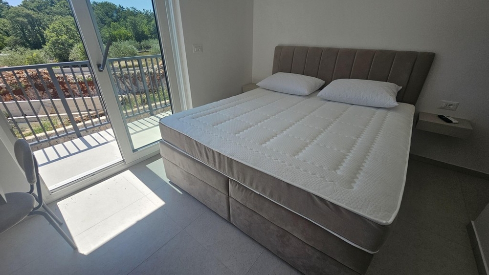 Schlafzimmer mit Doppelbett und Balkontür