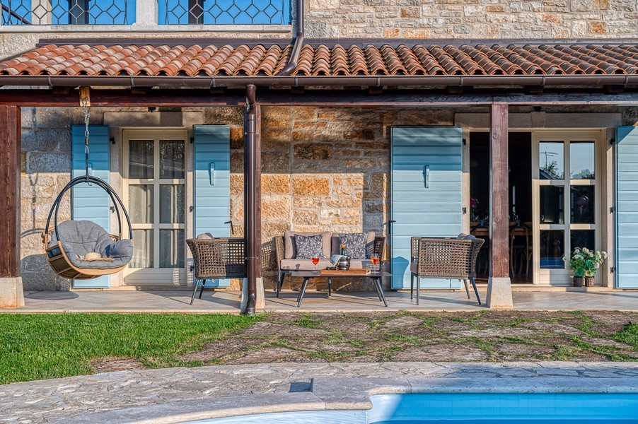 Sitzbereich unter dem Terrassendach neben dem Pool