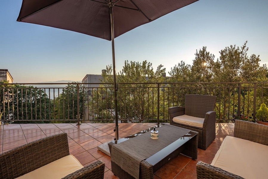 Terrasse mit Sitzgelegenheiten und Meerblick in Kroatien, ideal für Wohnungssuchende