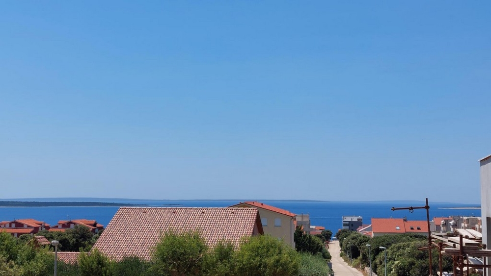 Immobilien Kroatien, Appartement mit Meerblick kaufen, Blick auf das Meer von einer erhöhten Position aus mit roten Ziegeldächern im Vordergrund - Panorama Scouting