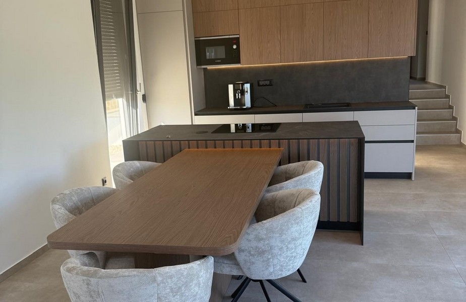 Küche mit Kochinsel und integriertem Sitzbereich