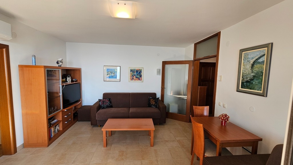 Wohnzimmer mit Sofa, TV-Möbeln und Essbereich