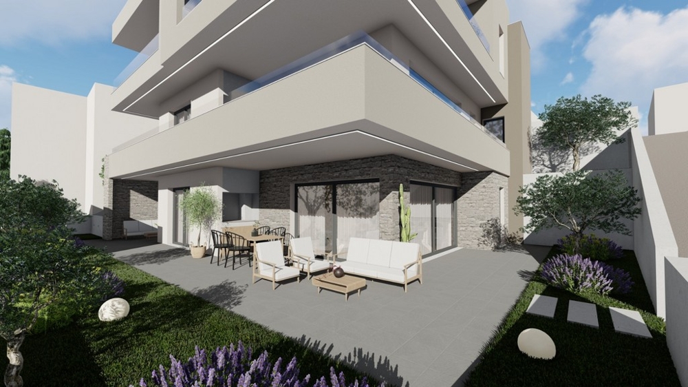 Überdachte Terrasse mit Loungemöbeln und Blick ins Grüne