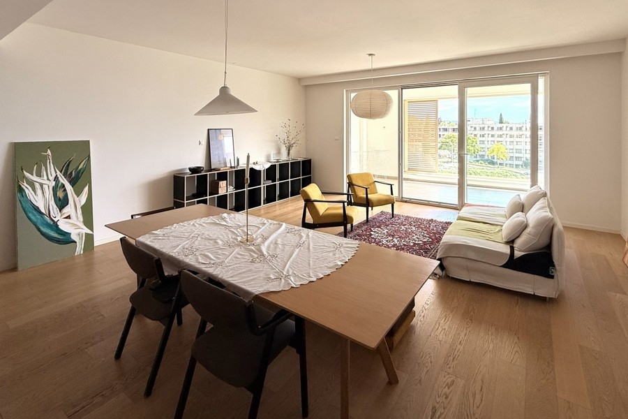 Wohnzimmer mit Sofa und Fensterfront
