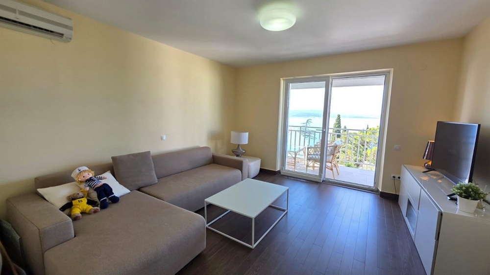 Wohnzimmer mit Sofa und Balkonzugang
