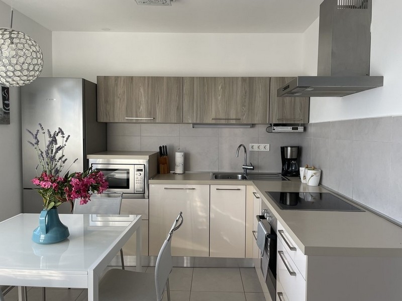 Moderne Küche mit weißer Einbauküche in der Wohnung in Murter
