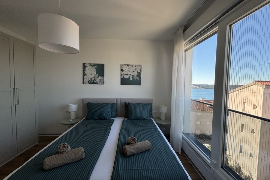 Schlafzimmer mit Fenster und Blick auf das Meer in Trogir