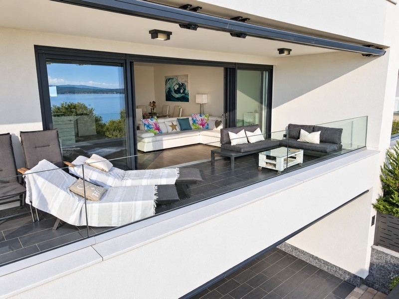 Terrasse mit Sonnenliegen und Loungemöbeln