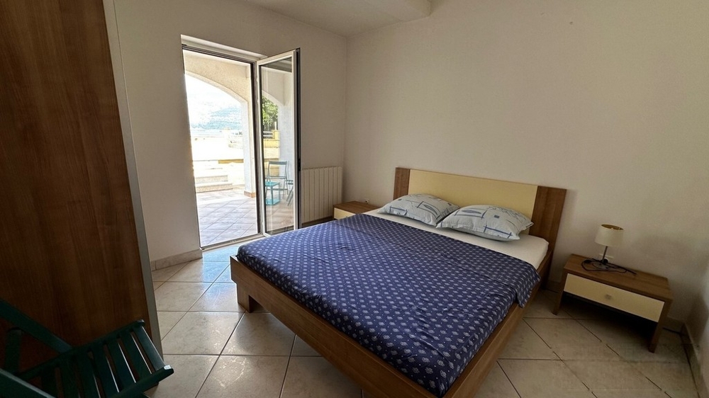 Schlafzimmer mit Doppelbett und Zugang zur Loggia