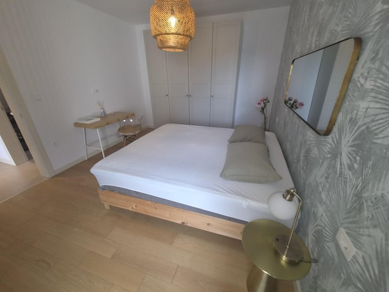 Schlafzimmer mit Doppelbett und Wandspiegel
