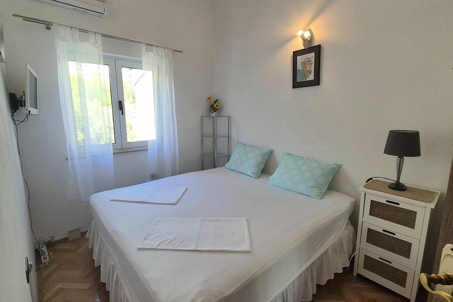 Schlafzimmer mit Nachttisch und Fenster