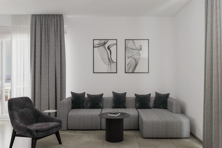 Wohnzimmer mit grauem Ecksofa und Sessel