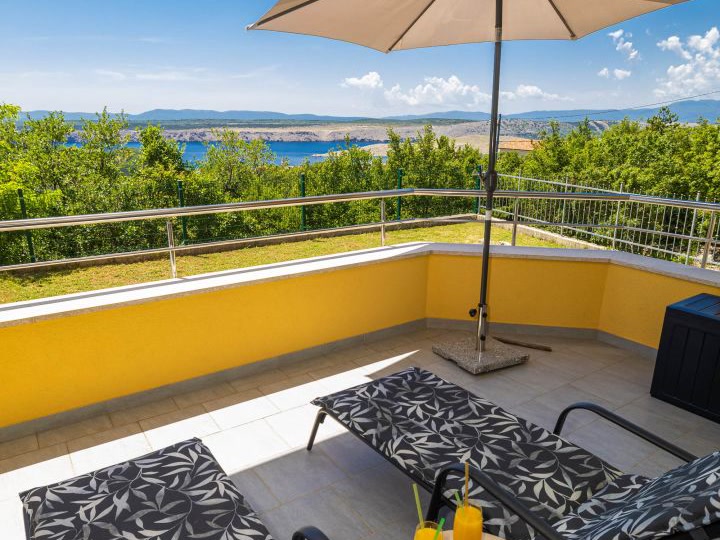 Loggia mit Liegen und Blick auf das Meer